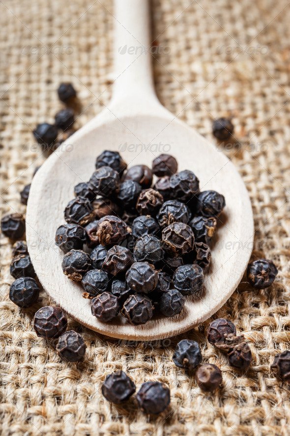 black pepper on the wooden spoon