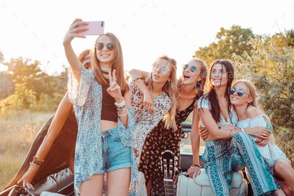 Six beautiful girls make selfie in nature in the countryside