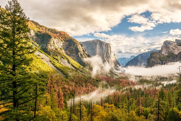 Yosemite National Park Valley at cloudy autumn morning from Tunnel View. Low clouds lay in the valley. California, USA.