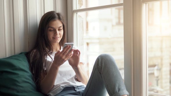 Girl Browses Information on Phone