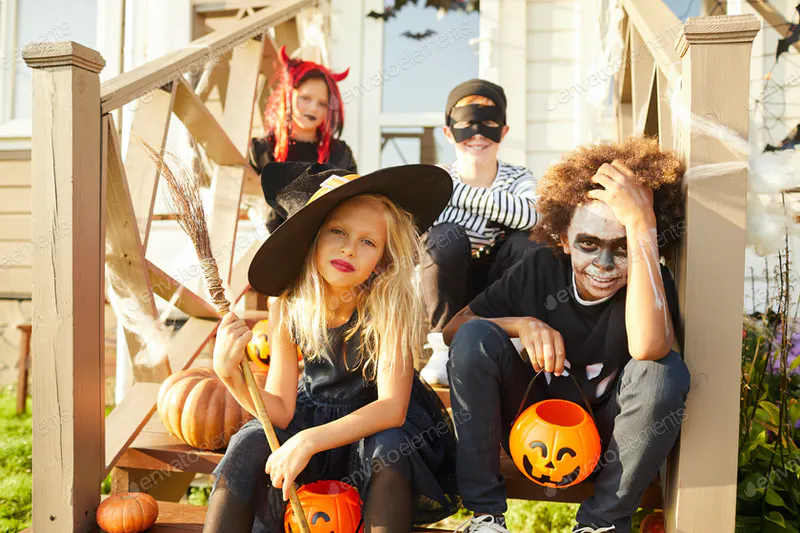 Kids Sitting on Porch on Halloween